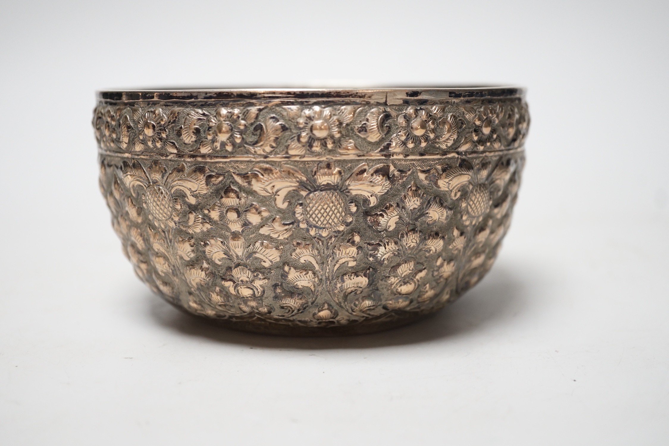 A Chinese Straits? embossed white metal bowl, indistinct marks to the base, diameter 13.9cm, 4.8oz.